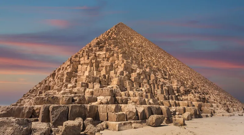 The Great Pyramid of Giza glowing under a pink sunset sky