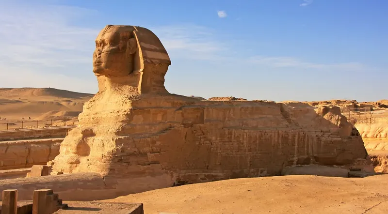 The Great Sphinx of Giza in profile against a blue sky