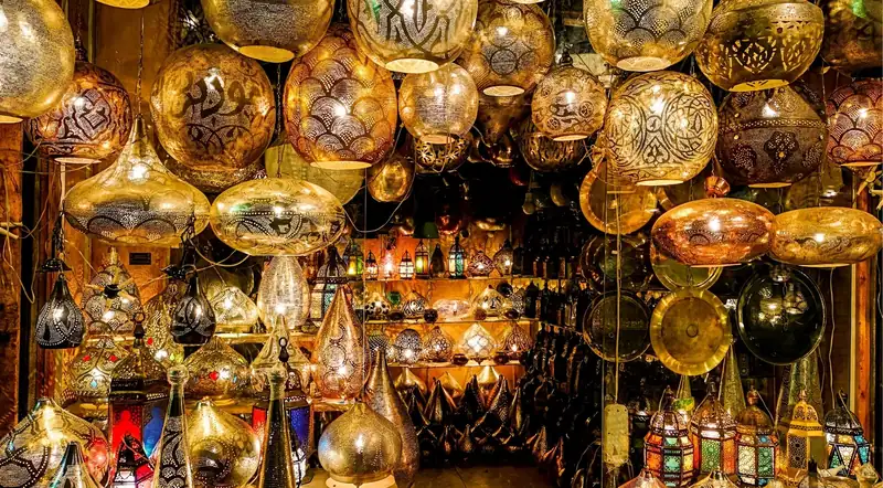 Glowing brass lanterns hanging in the Khan el-Khalili bazaar